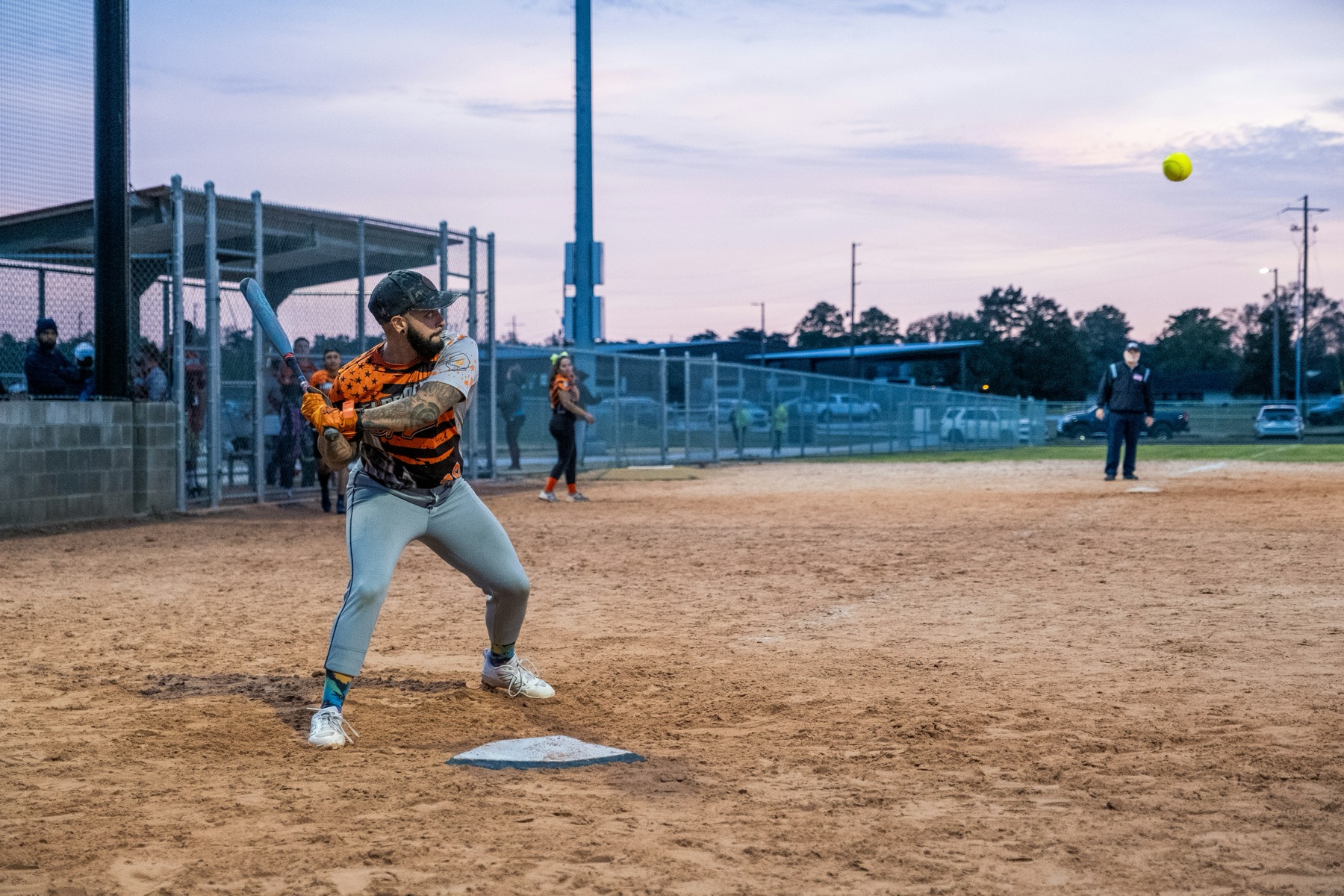 Softball batter waiting for a pitch at dusk