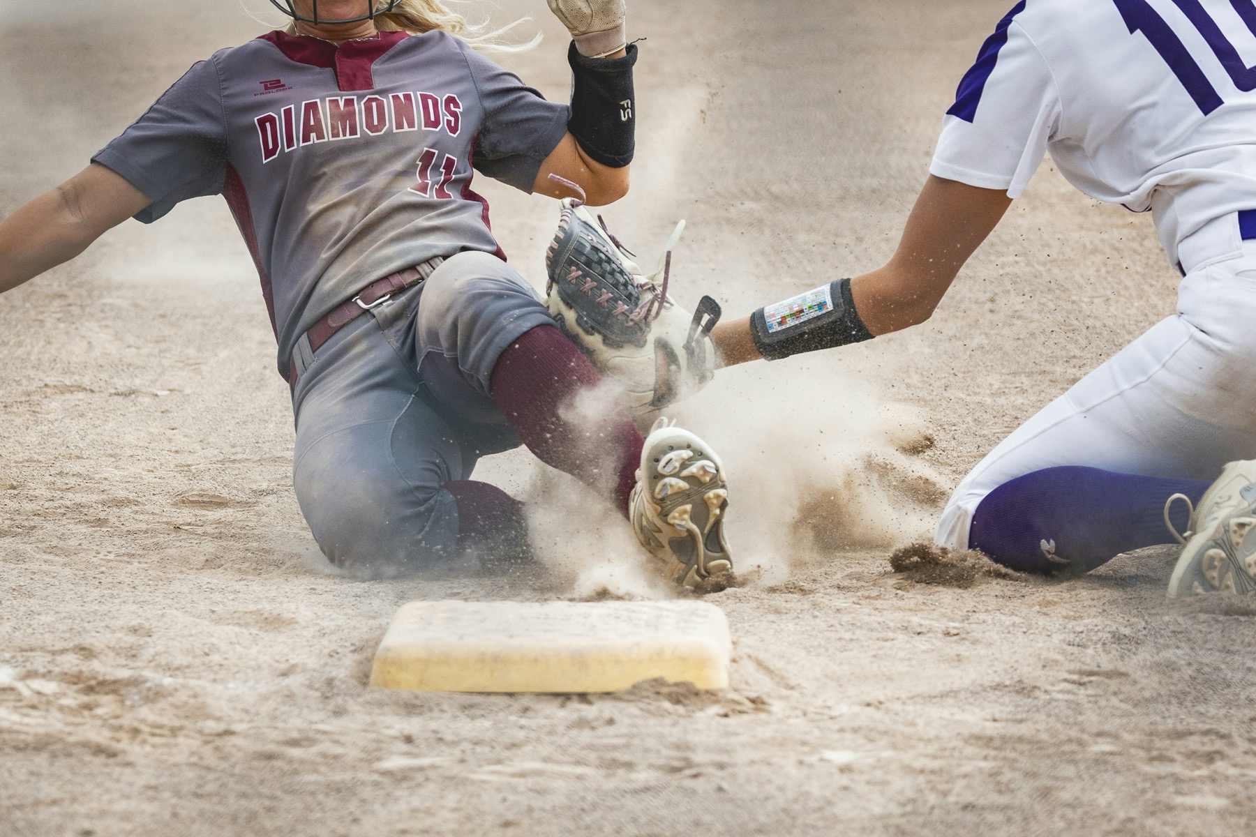 Softball runner sliding into base